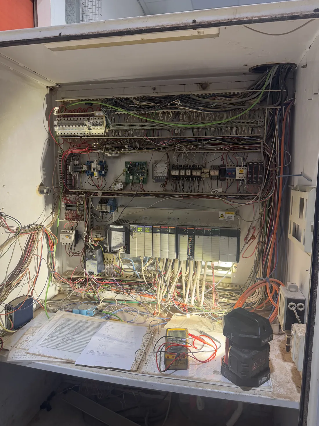 Legacy control panel with drawings out during fault finding