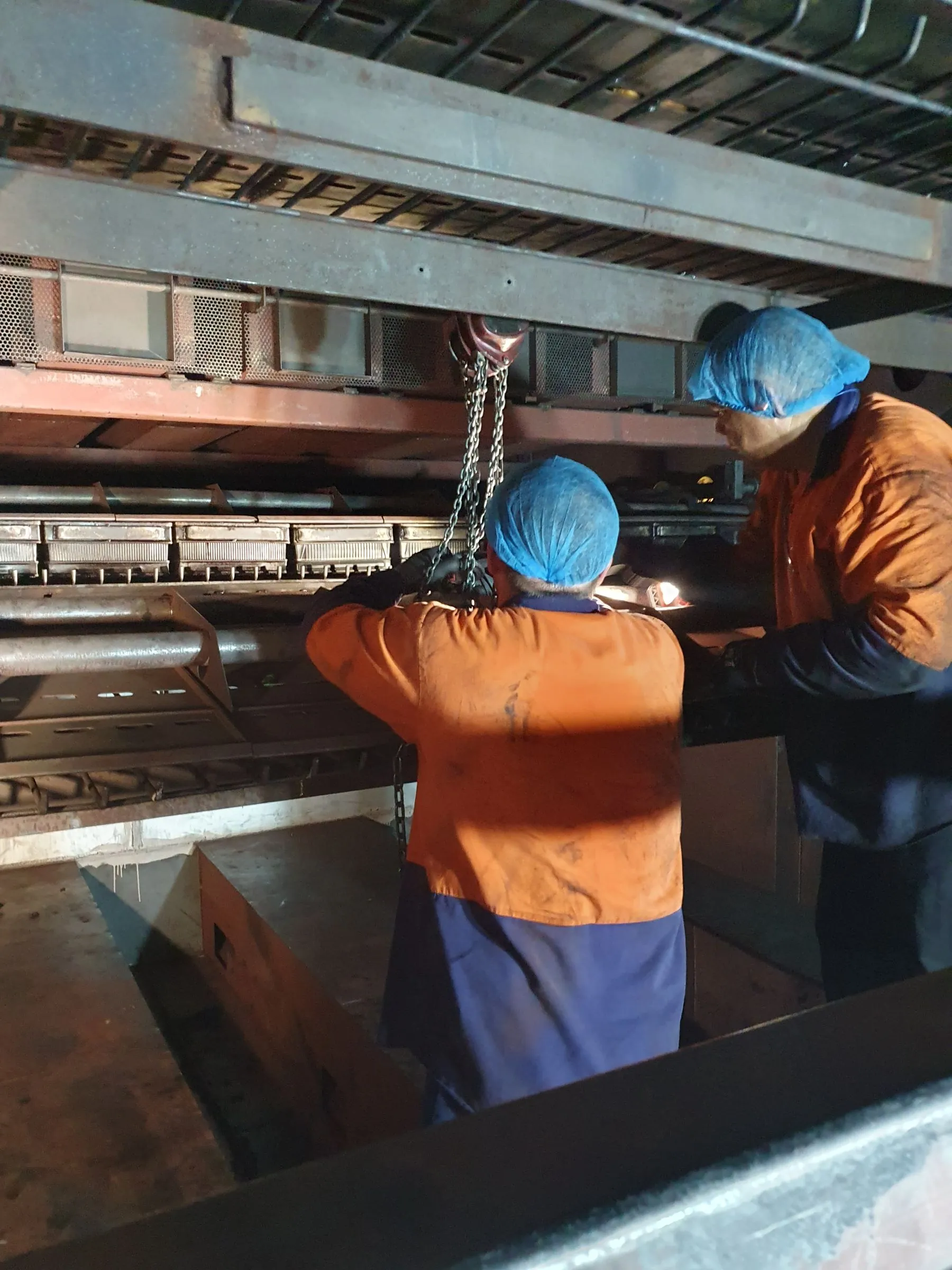 Sparktech electricians working together inside production plant